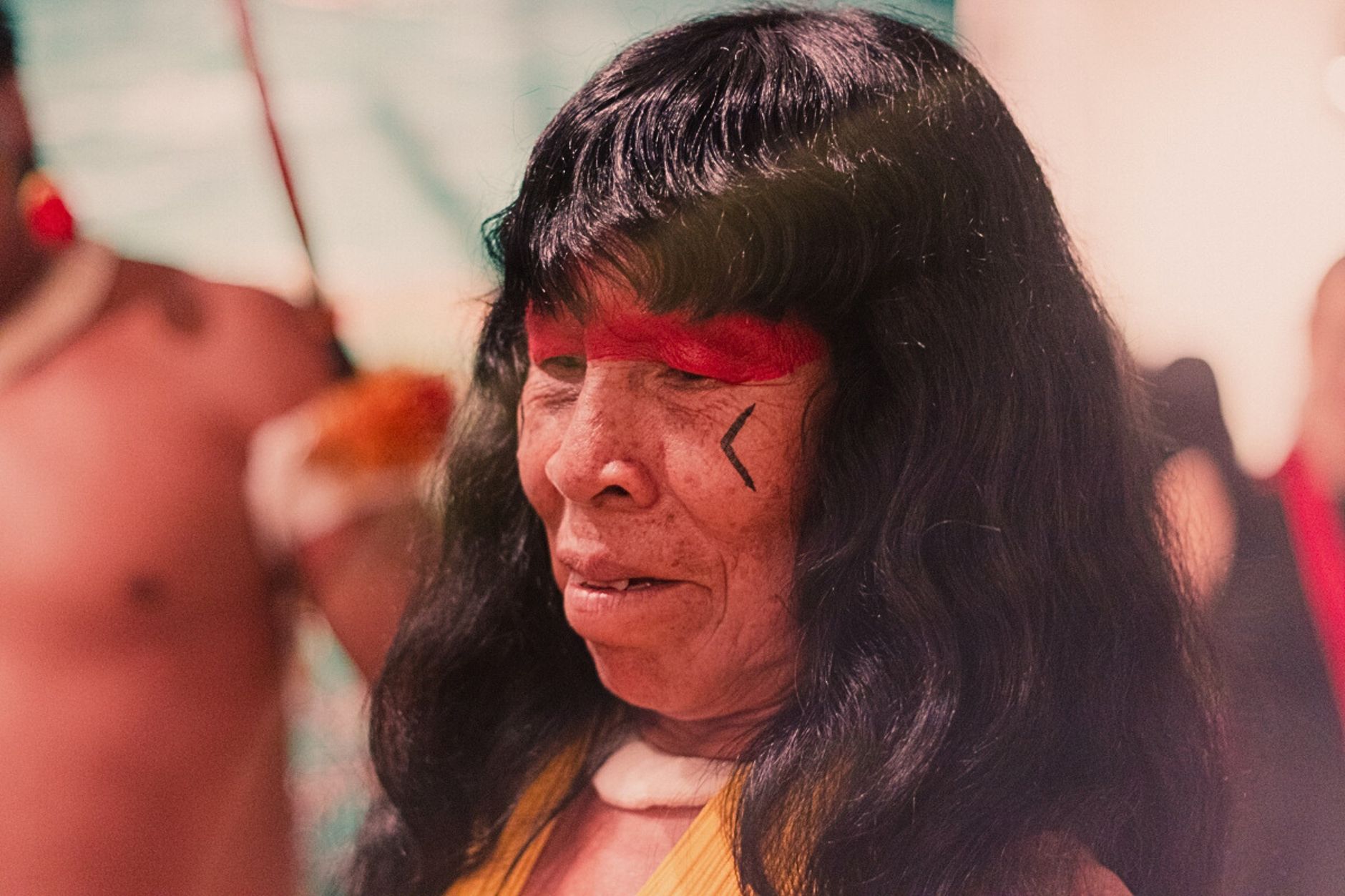 Close-up of an indigenous woman with traditional red face paint in Brazil.