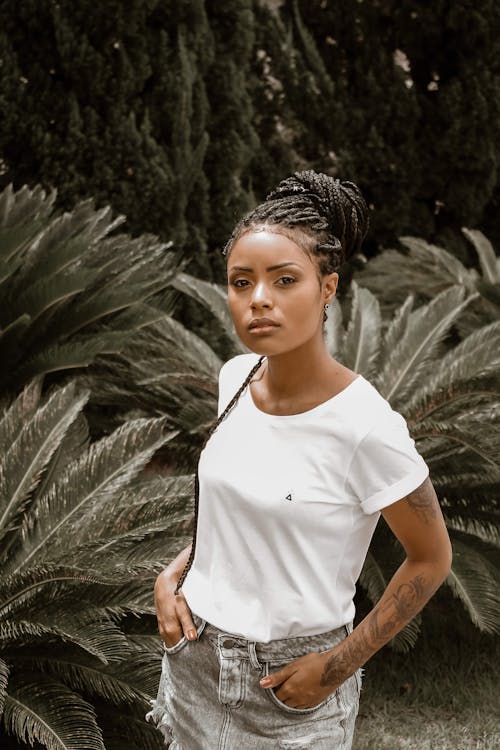 Woman Wearing White Crew-neck T-shirt Standing Near Green Sago Palm Plant