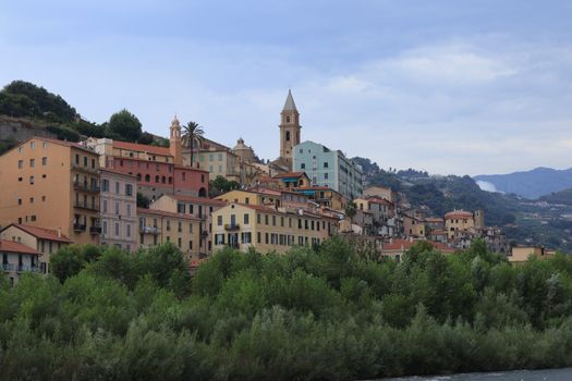 Picturesque Italian village with colorful buildings and lush greenery at twilight.