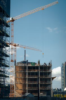 Cranes and building under construction against blue sky in Bratislava, Slovakia.