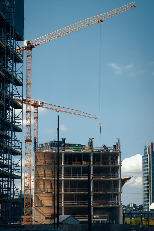 Free Cranes and building under construction against blue sky in Bratislava, Slovakia. Stock Photo