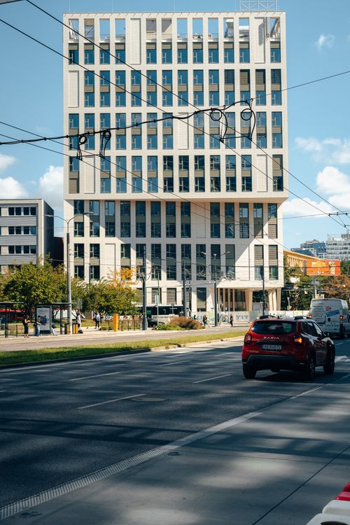 Free Daytime view of a modern building in Bratislava with cars on the street, showcasing urban architecture. Stock Photo