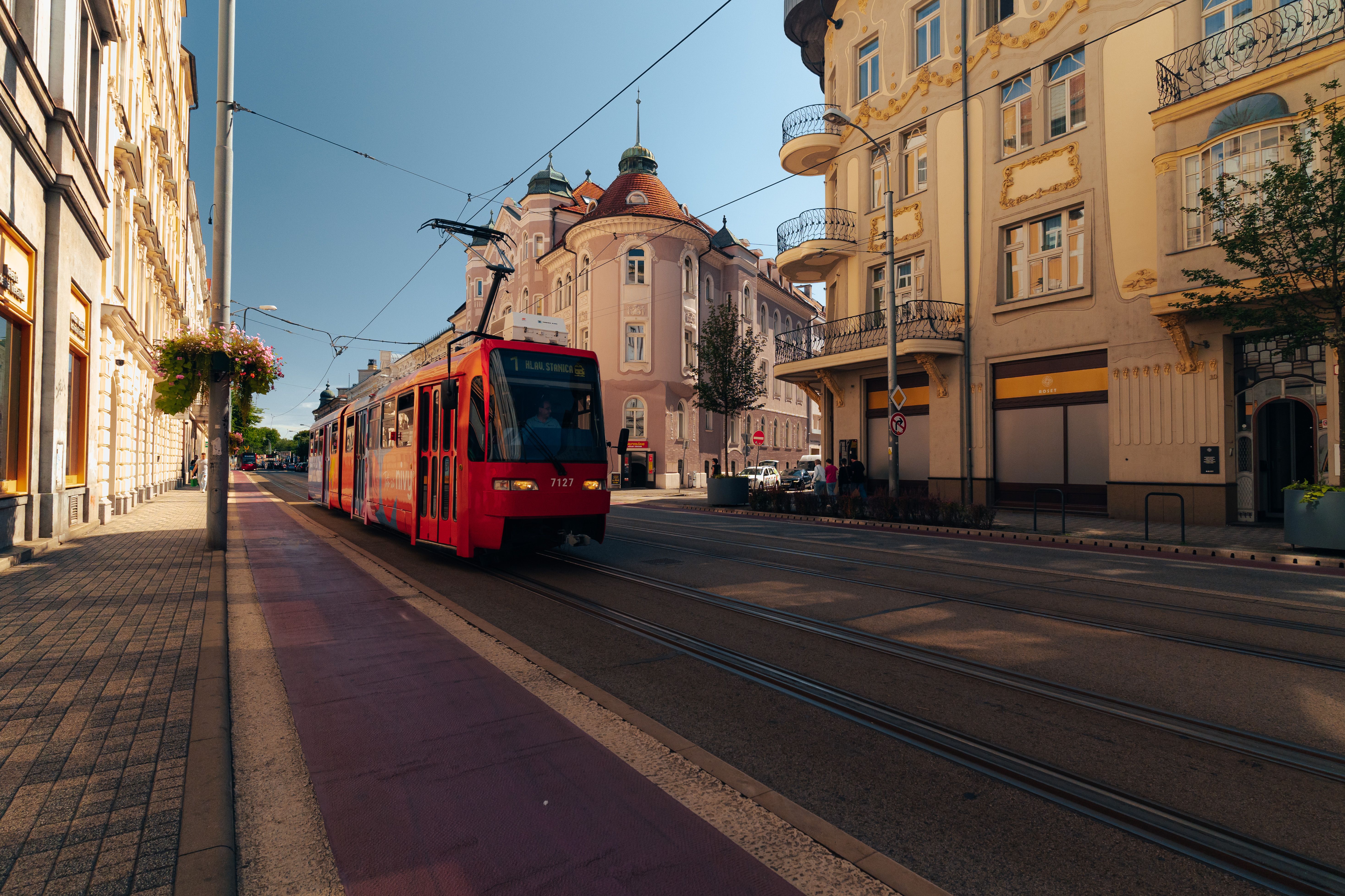 A public bus in Bratislava, Slovakia, driving through the city streets, representing airport transfers.