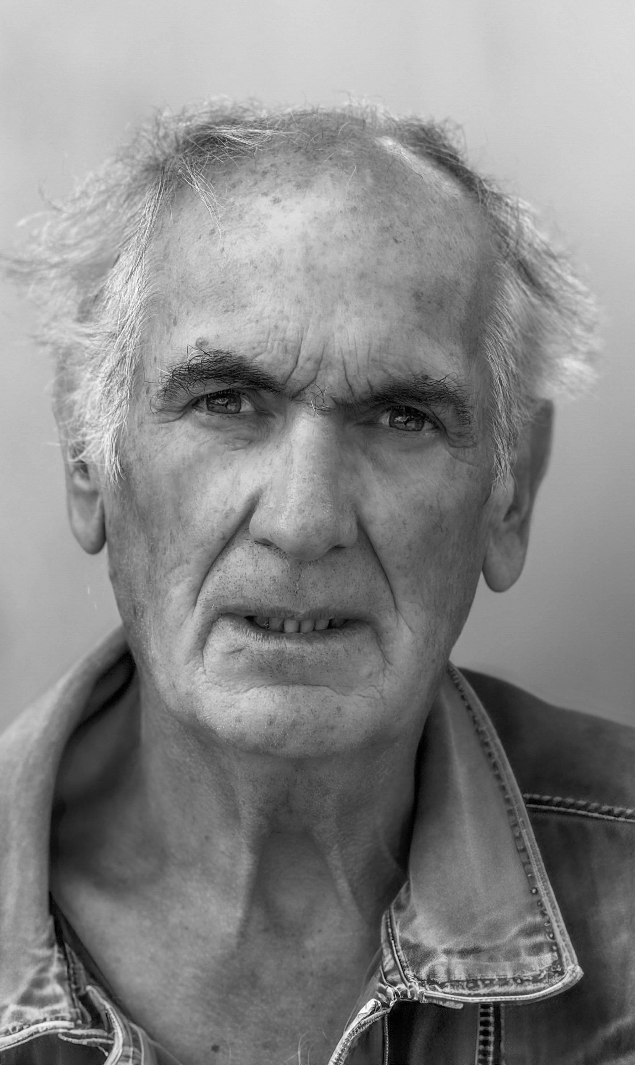 Black and white portrait of a senior man with thoughtful expression.