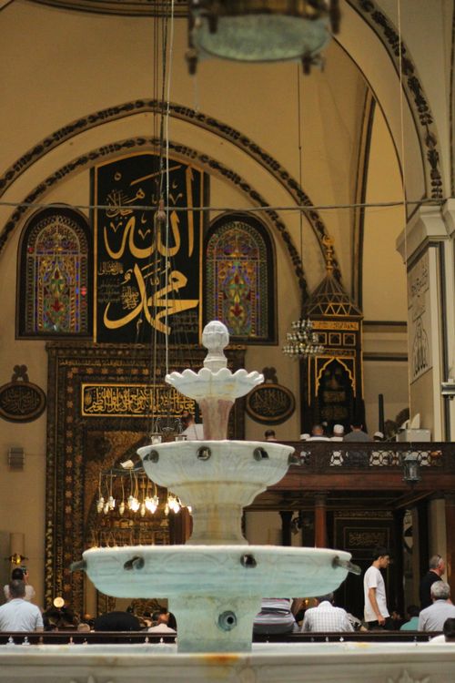 Free Beautiful mosque interior with a central fountain and intricate decorations. Stock Photo