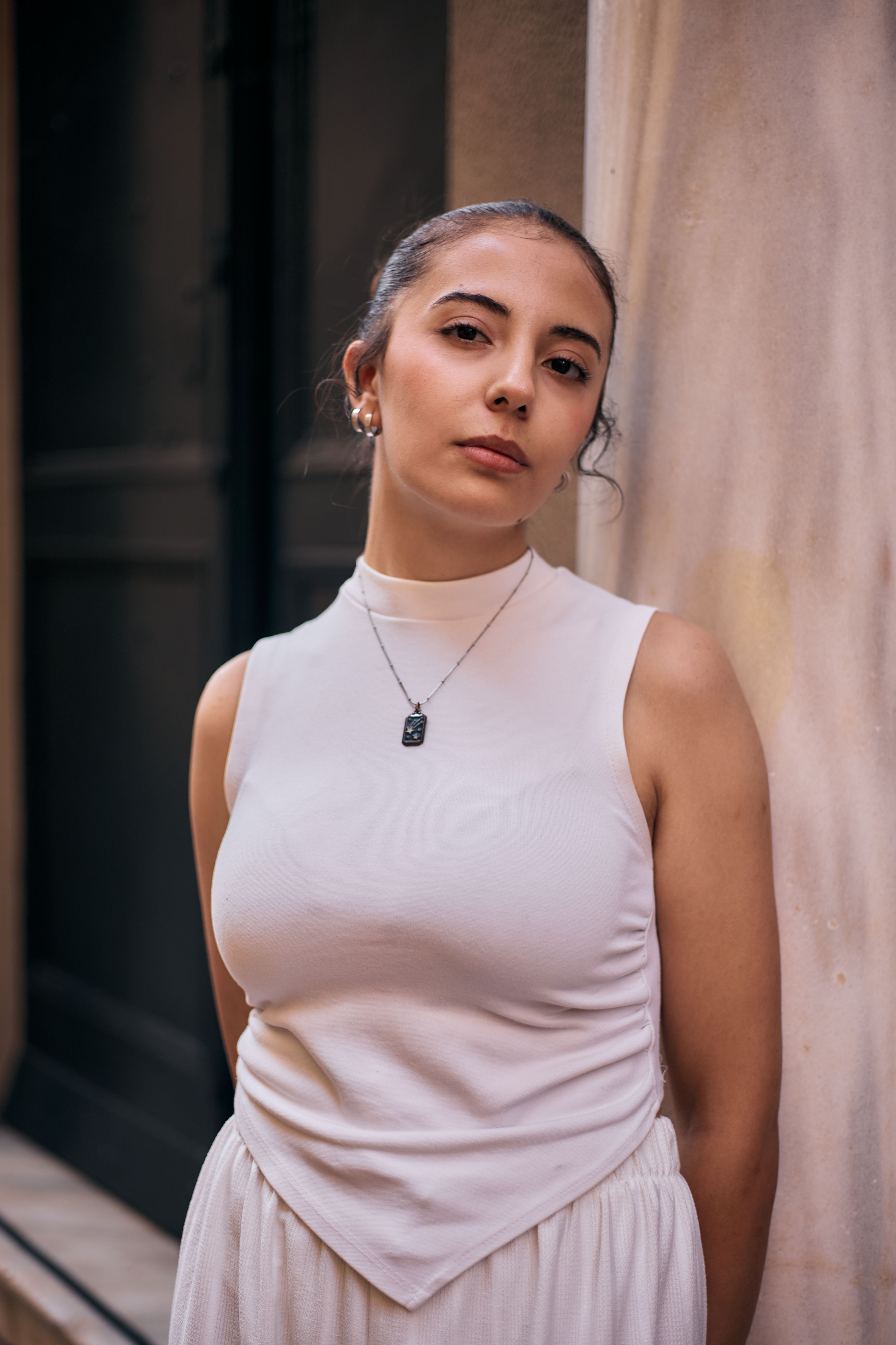 Portrait of a stylish woman in Istanbul, showcasing modern fashion and serene confidence.