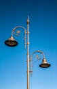 Elegant Street Lamps Against Clear Blue Sky