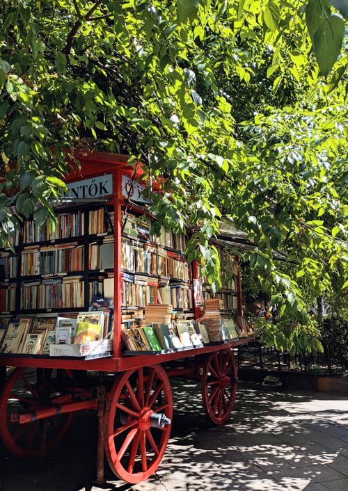 Free Discover a picturesque outdoor book cart in Budapest, Hungary, basking in the summer sun, perfect for literature lovers. Stock Photo