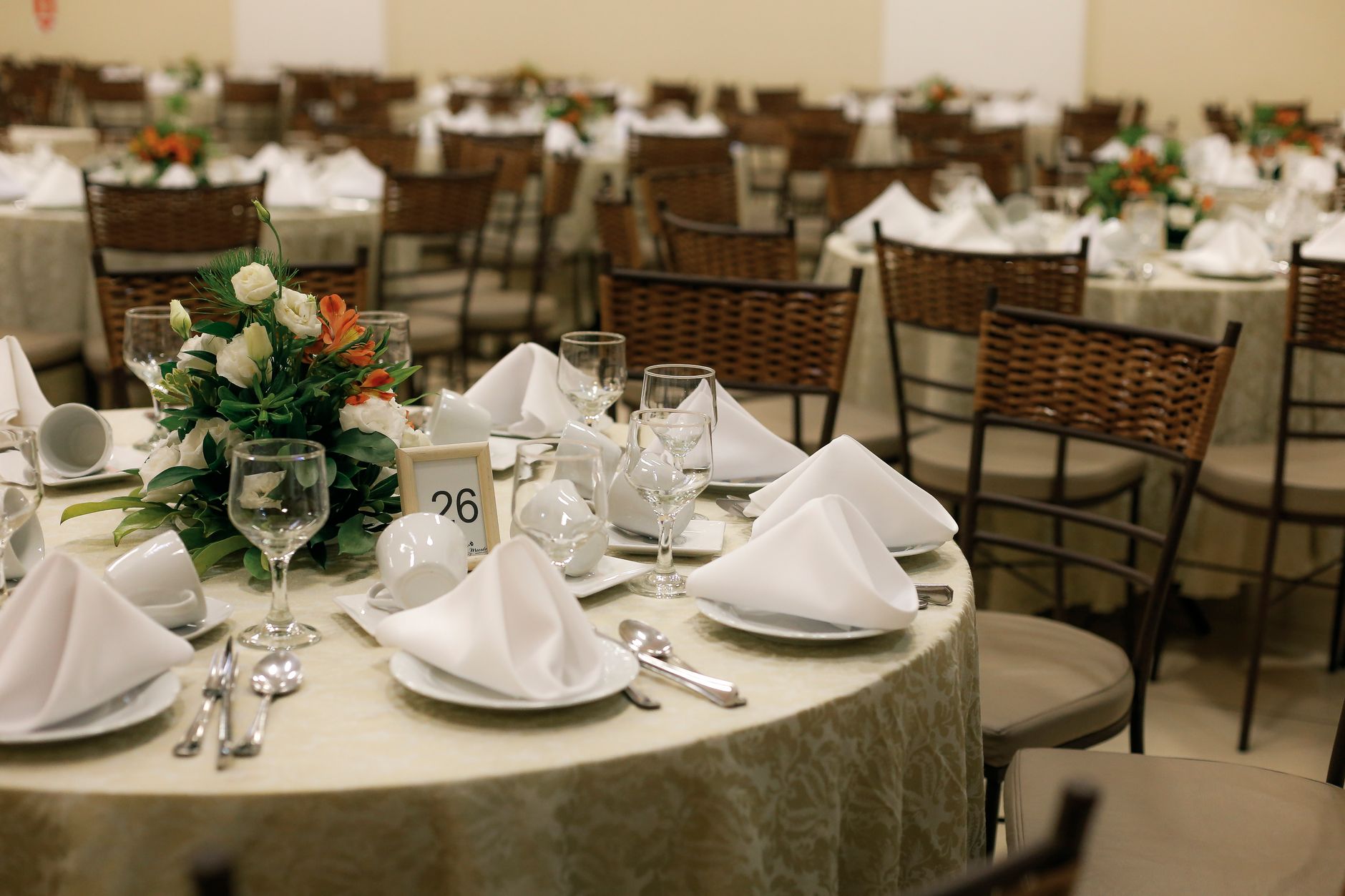 Beautifully arranged tables with floral centerpieces for an elegant wedding reception.