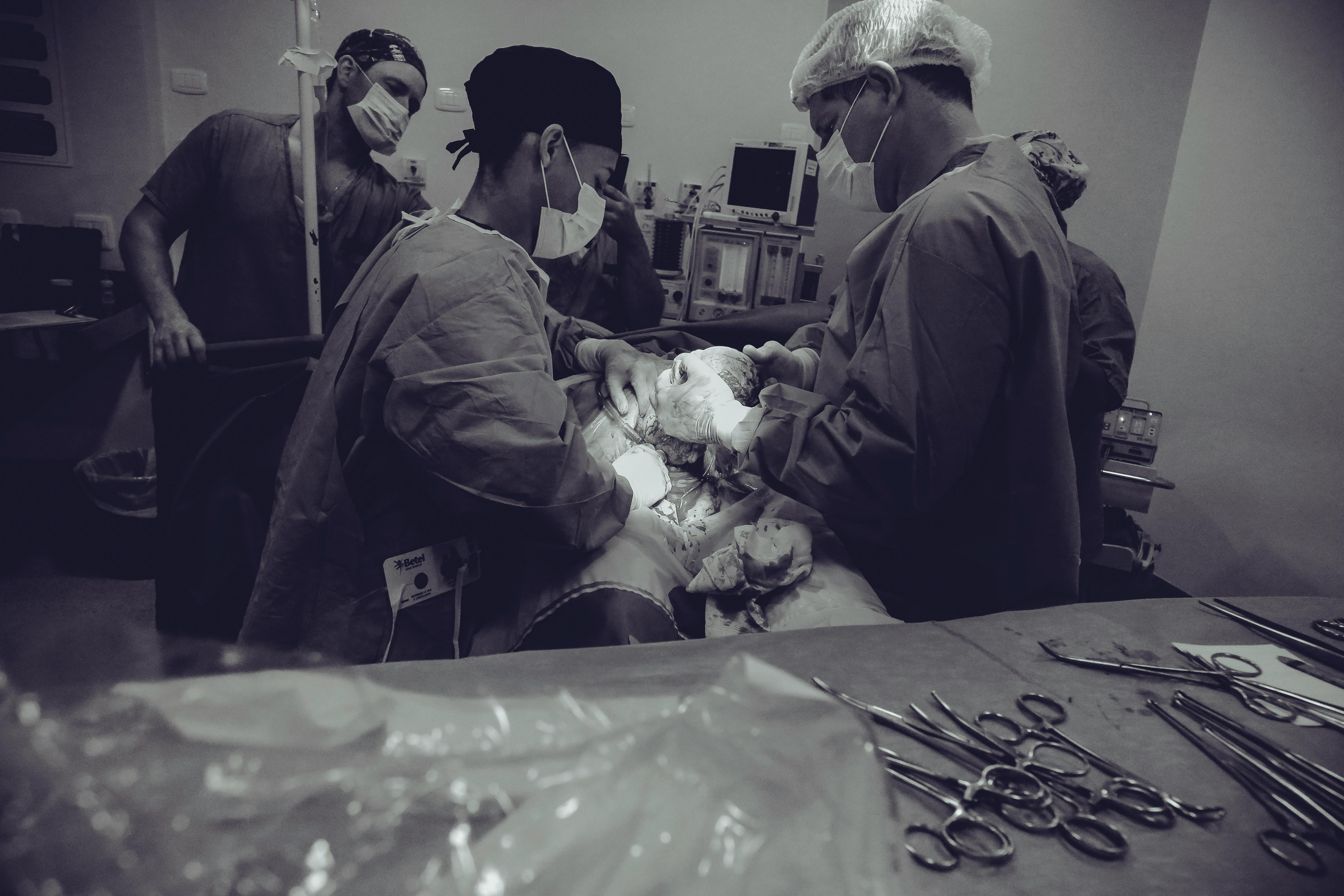 A surgeon and patient in consultation, looking at a tablet with medical images