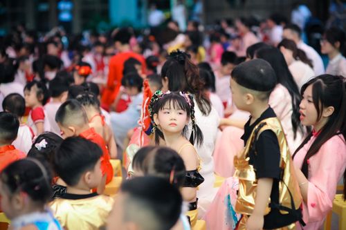 Free A vibrant gathering of children in Hà Nội, Việt Nam, wearing colorful traditional costumes during a festive celebration. Stock Photo