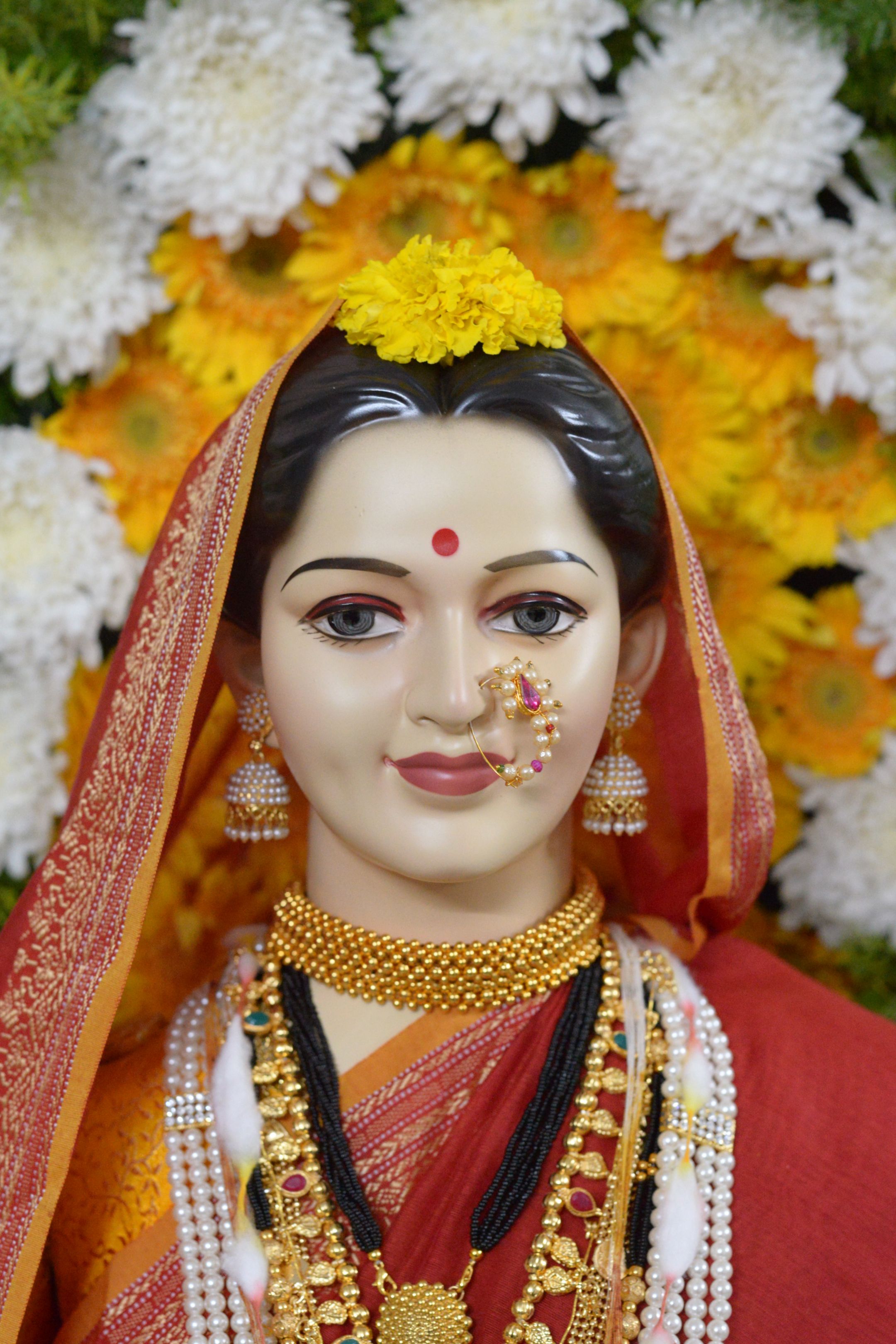 Beautifully adorned Gauri idol with flowers for Ganesh Chaturthi celebration in Pune.