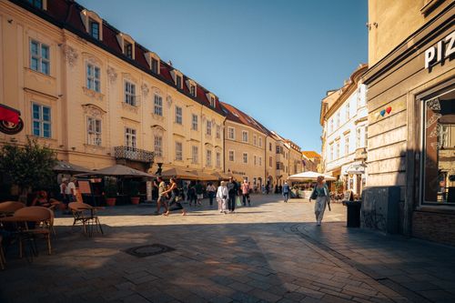 Free Explore the vibrant streets of Bratislava's historic center on a sunny day, capturing its architectural charm and lively atmosphere. Stock Photo