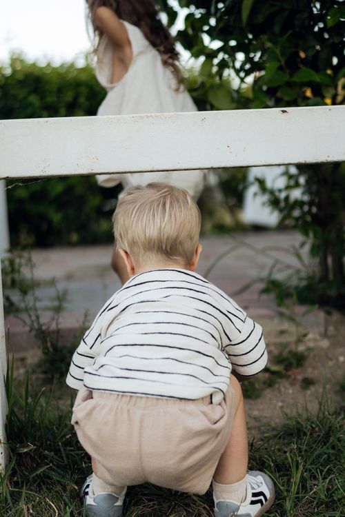 Free Young children playing in a garden on a sunny day, embracing summer activities. Stock Photo