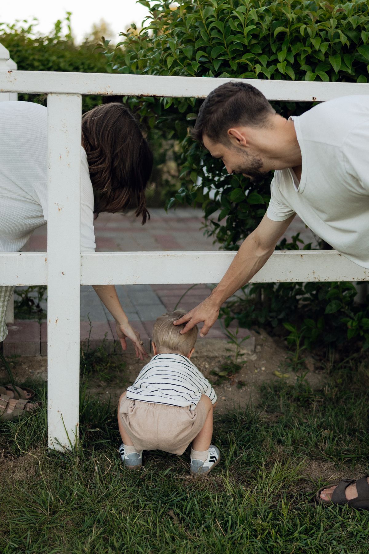 Parents supporting toddler
