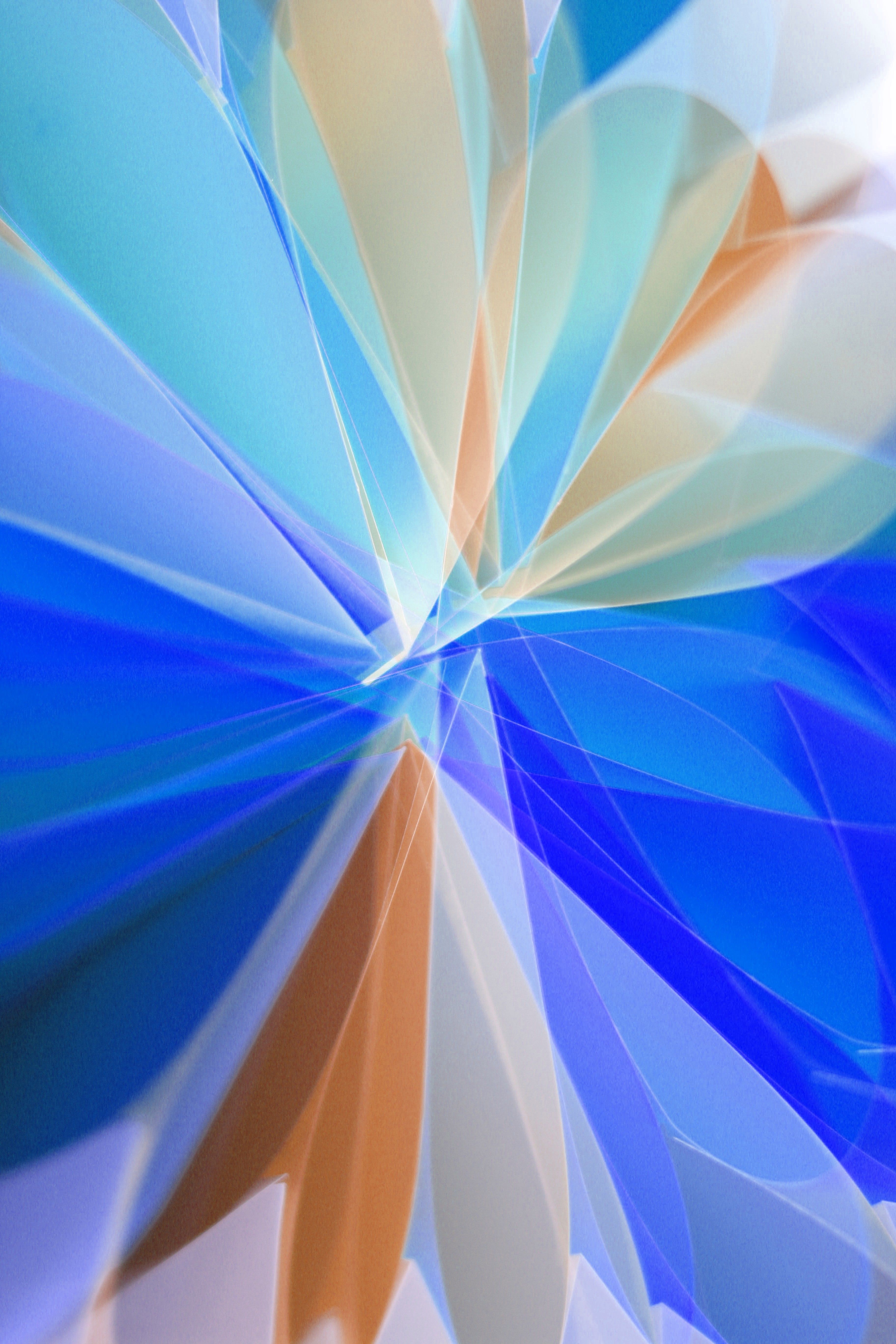 Vibrant abstract pattern of overlapping light streaks in blue and orange hues.