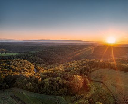Stunning aerial view of a sunset over lush forests and fields in Nelson, Wisconsin.