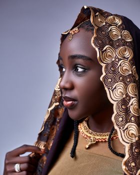 A captivating portrait of a woman in traditional Nigerian attire featuring intricate embroidery.