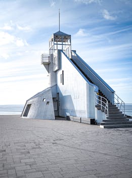 Striking blue sky frames a modern white lighthouse in Oulu, Finland.