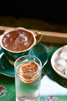 A stylish coffee setup with a cup of coffee, citrus garnish, and sweets, perfect for lifestyle concepts.