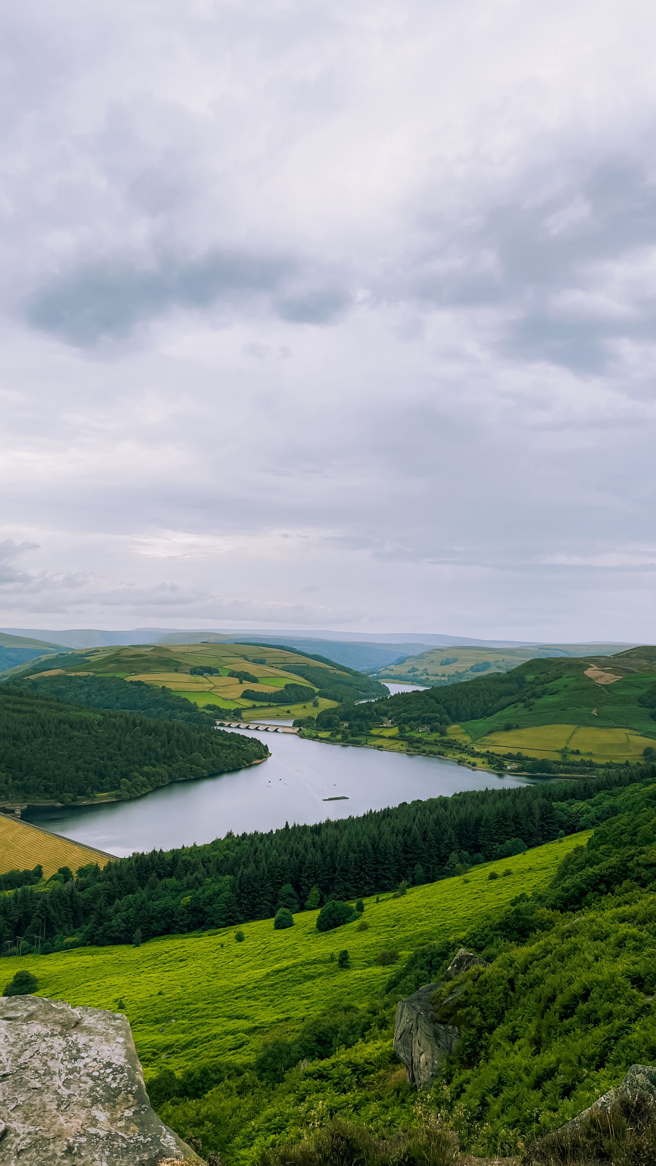 Discover the stunning landscapes of Bamford, England, showcasing lush greenery and a serene water reservoir.
