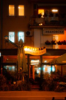 Warm, inviting nighttime view of a cozy restaurant in Ohrid, North Macedonia.