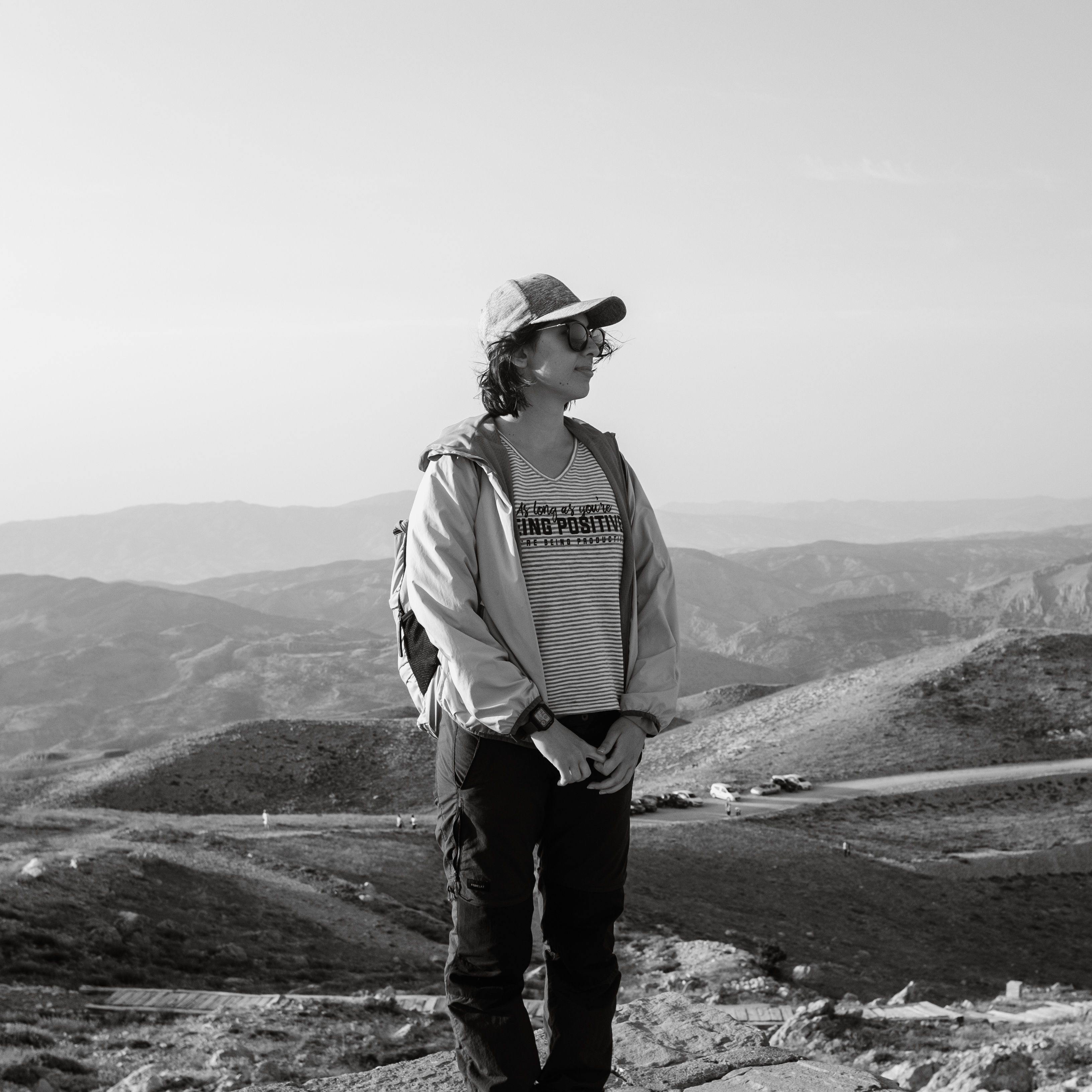 individual standing in sagebrush with distant mountains behind