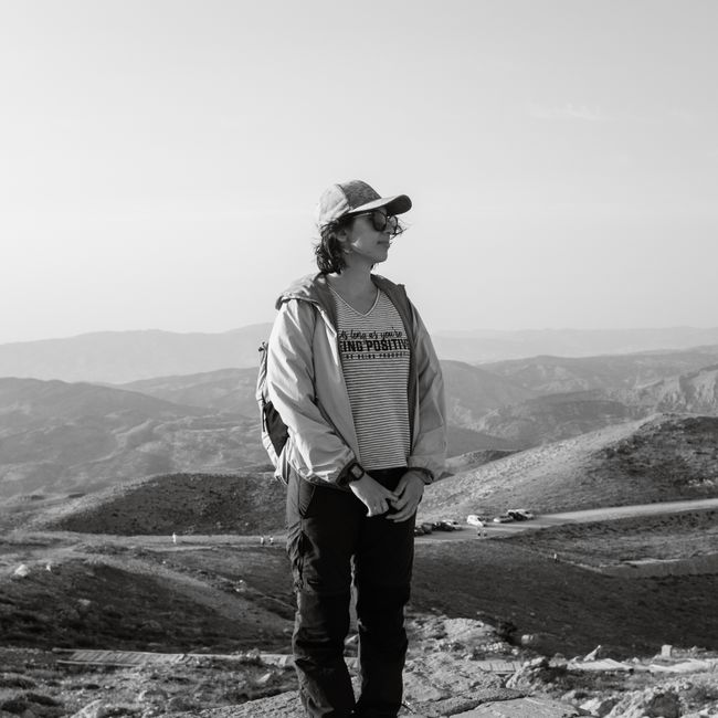 individual standing in sagebrush with distant mountains behind