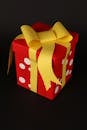 Colorful Gift Box with Yellow Bow on Dark Background