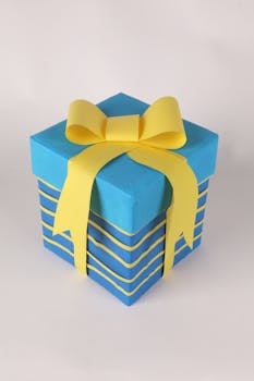 Blue gift box with vibrant yellow ribbon, ideal for celebrations and gift ideas.