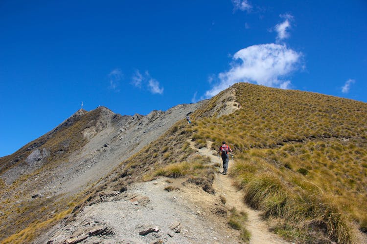 A Person Climbing A Mountain