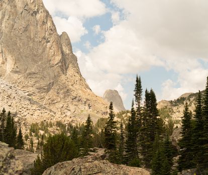 Majestic mountain landscape in Wind River Range, Wyoming with pine trees and clear skies.
