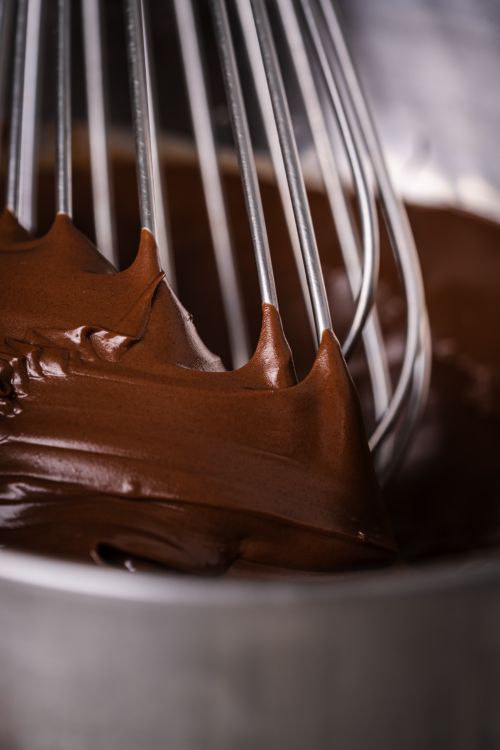 Free Indulge in the richness of chocolate ganache being whipped to perfection, highlighting its creamy texture. Stock Photo