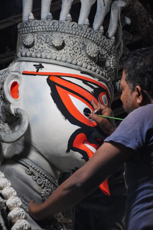 Free Close-up of an artist painting a Durga idol in a Kolkata workshop, capturing intricate details and cultural essence. Stock Photo