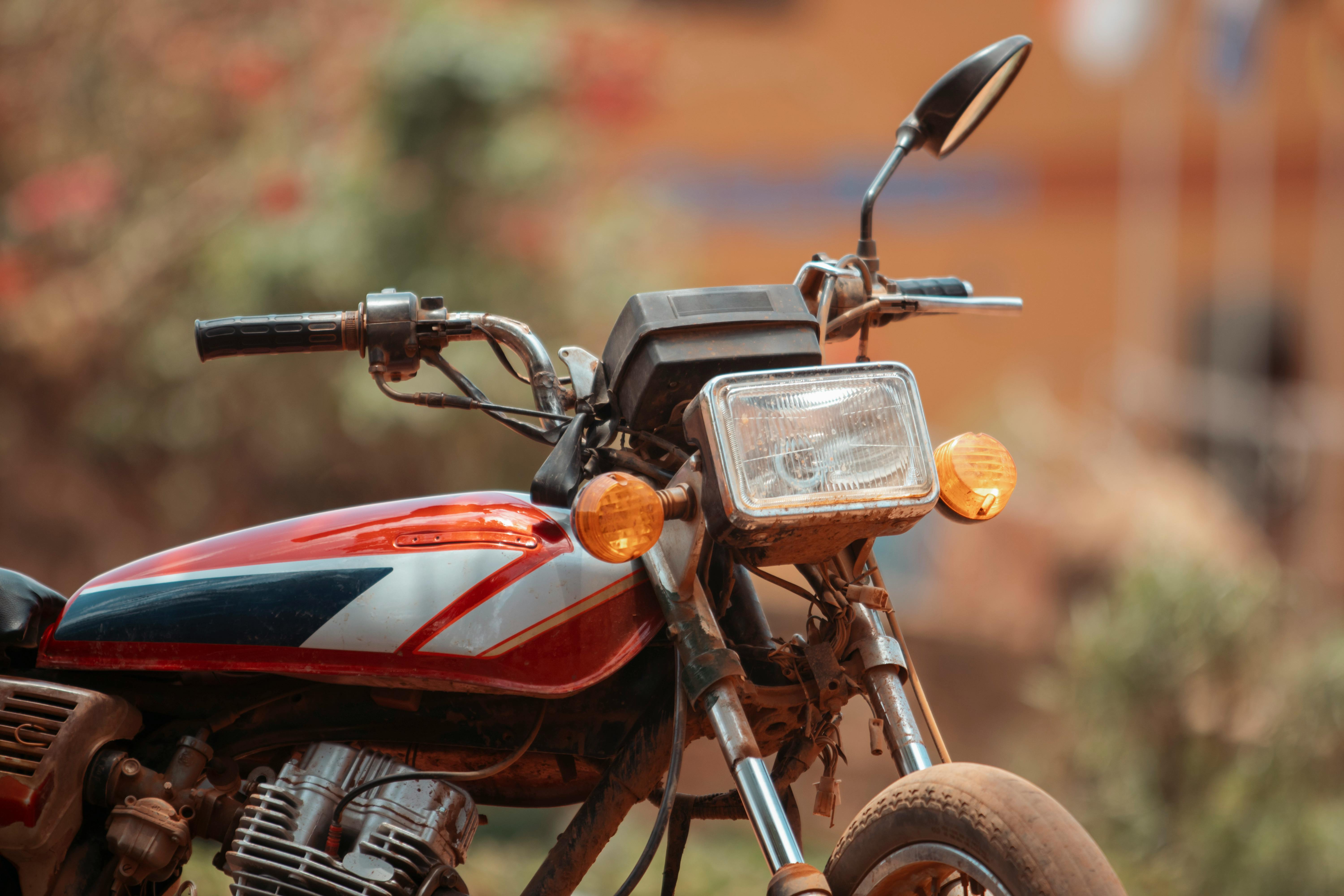 Close-up shot of a motorcycle parked outdoors in a rural setting in Uganda.