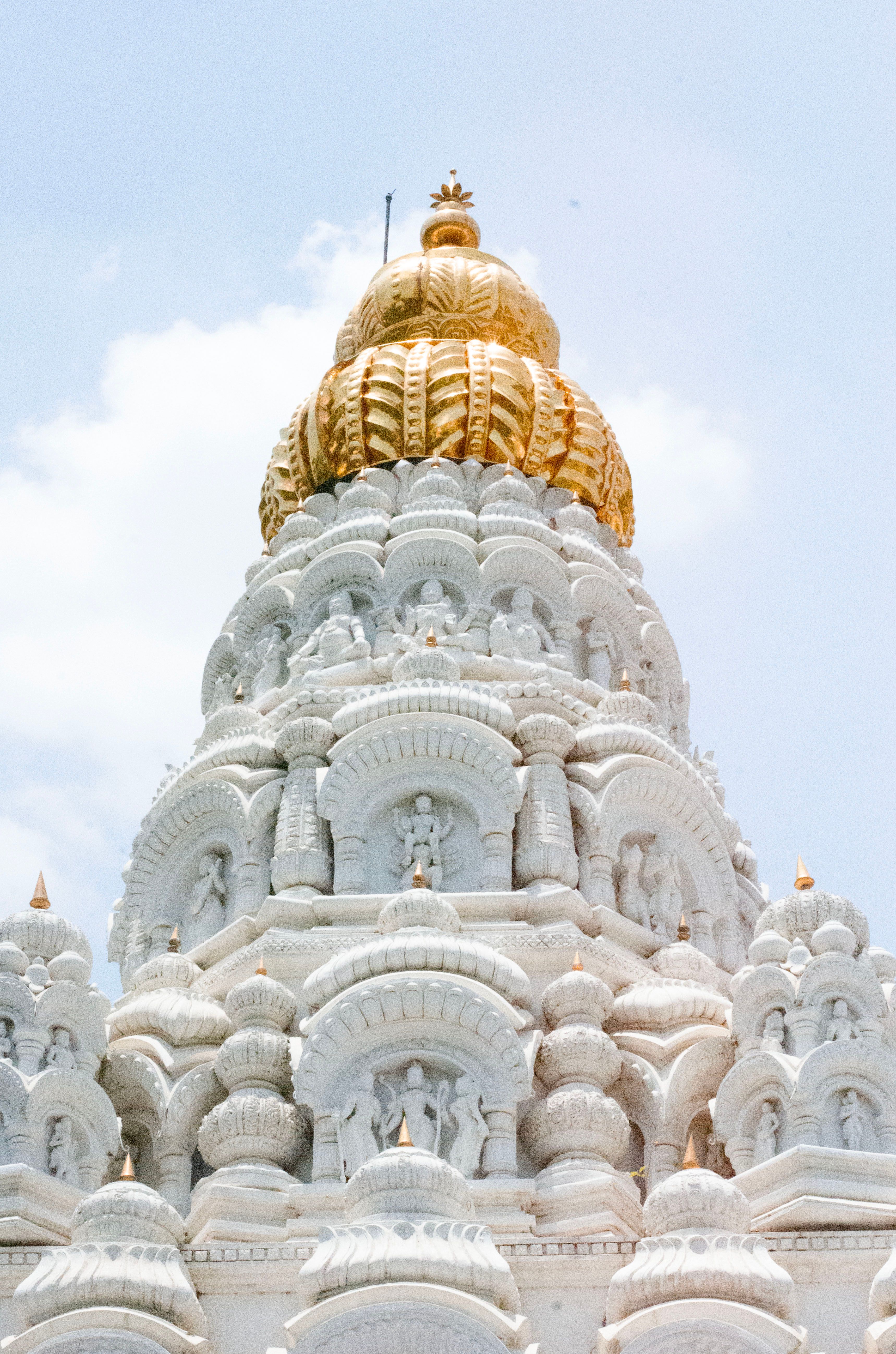 Intricate temple tower in Solapur, Maharashtra, showcasing traditional Indian architecture under a clear sky. | Indian Village Development