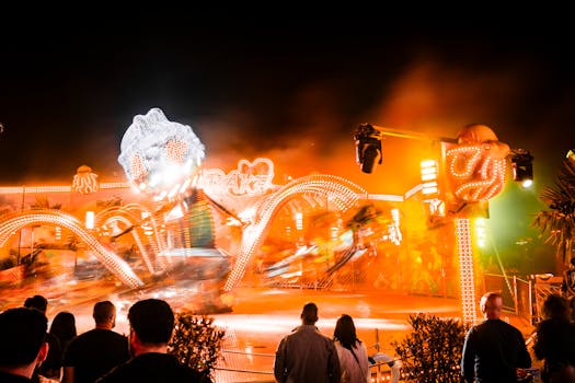 Vibrant nighttime carnival scene with dynamic lights and blurred ride motion.
