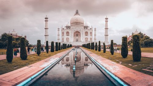Free Iconic view of the Taj Mahal with reflection in Agra, India during sunset, highlighting its architectural symmetry. Stock Photo