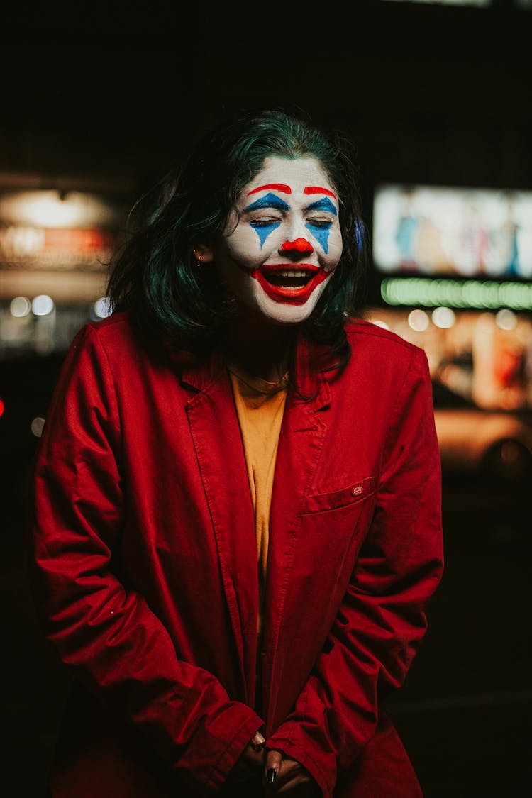 Shallow Focus Photo Of Person In Red Coat With Clown Face Paint