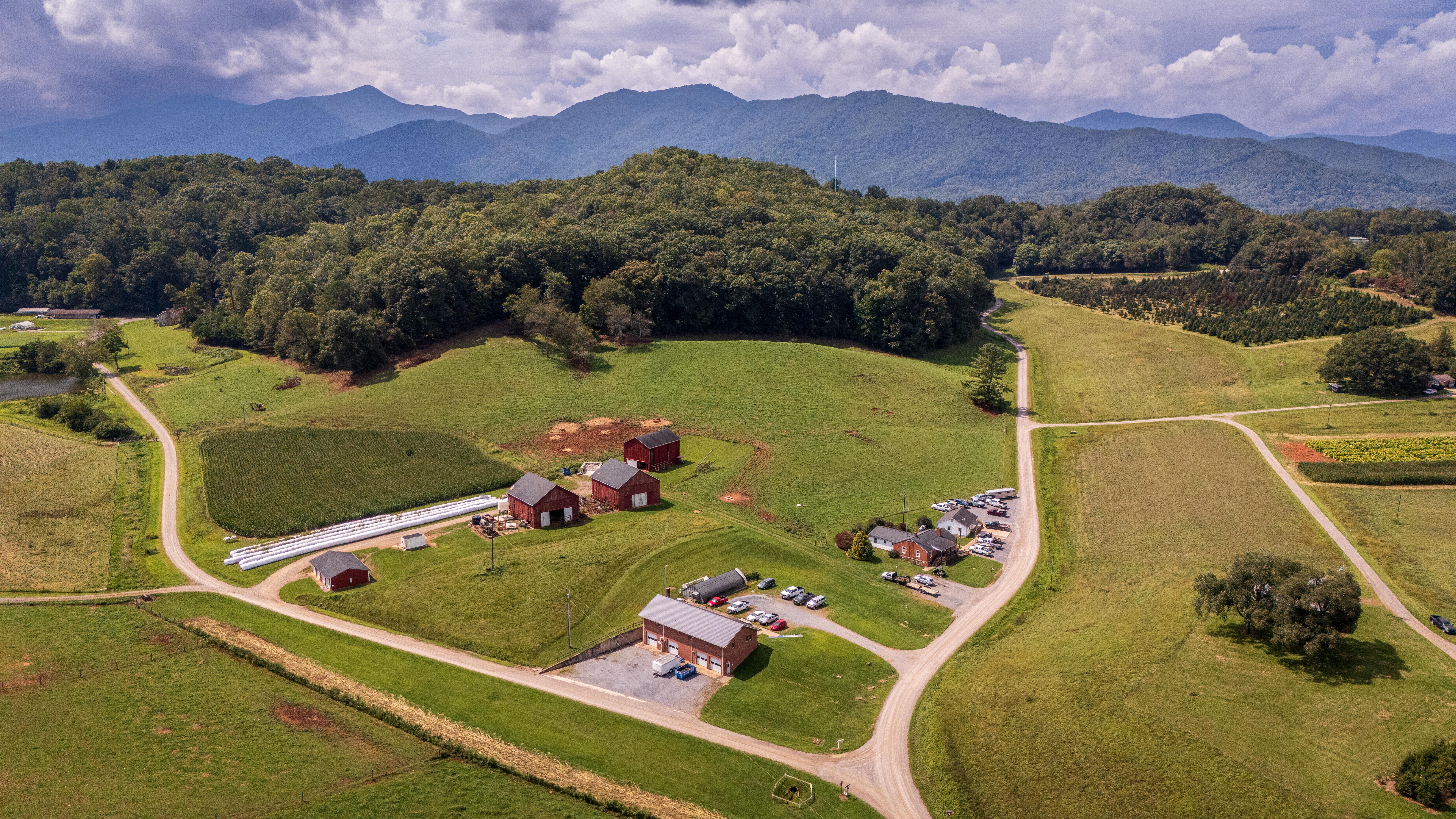 Aerial View of Farm Landscape with Distant Mountains · Free Stock Photo
