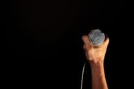 Person Holding Microphone
