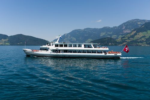 Free Scenic view of a passenger boat sailing on Lake Lucerne under a clear blue sky. Stock Photo