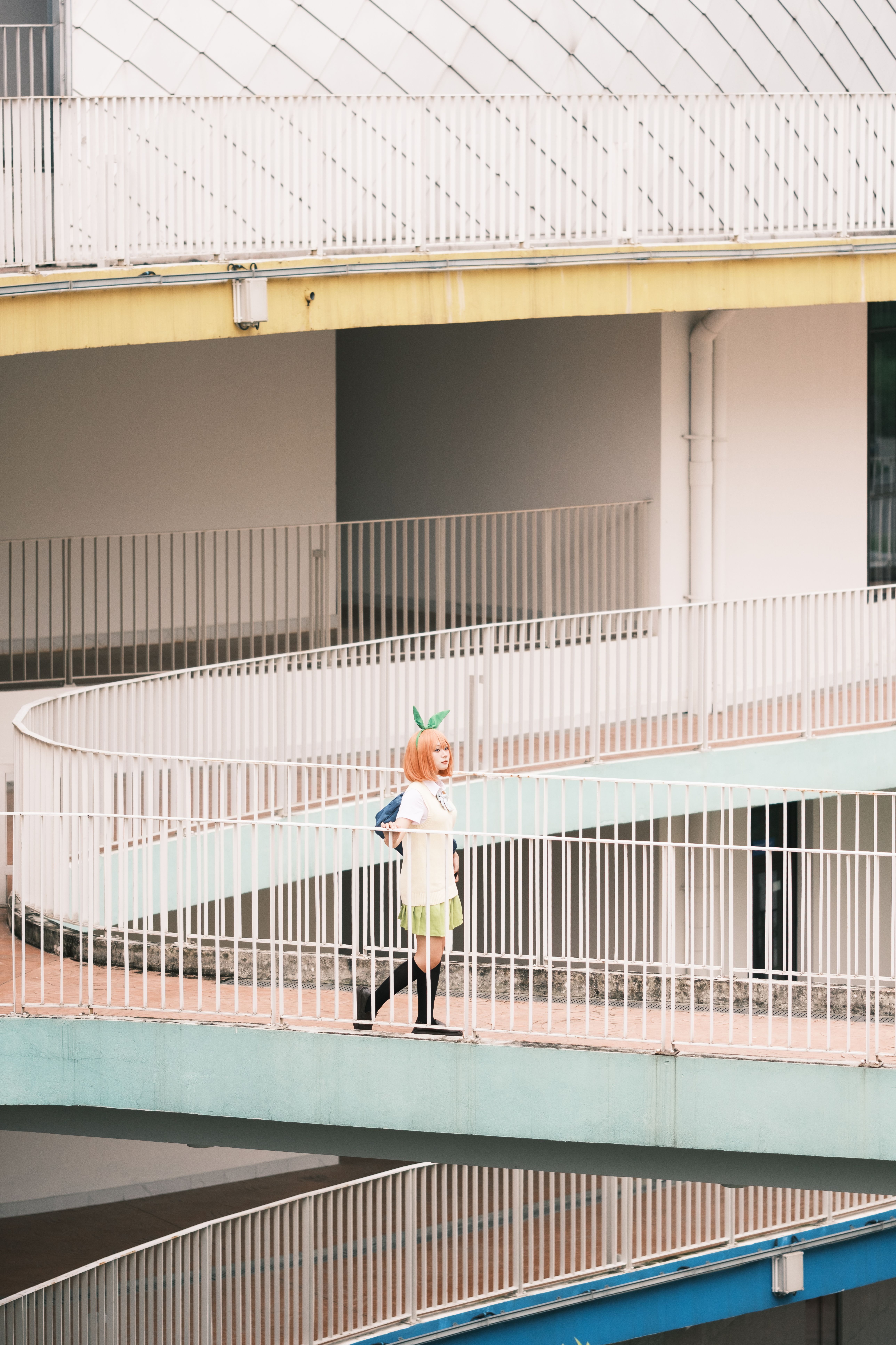 Person Walking Along Curved Urban Walkway