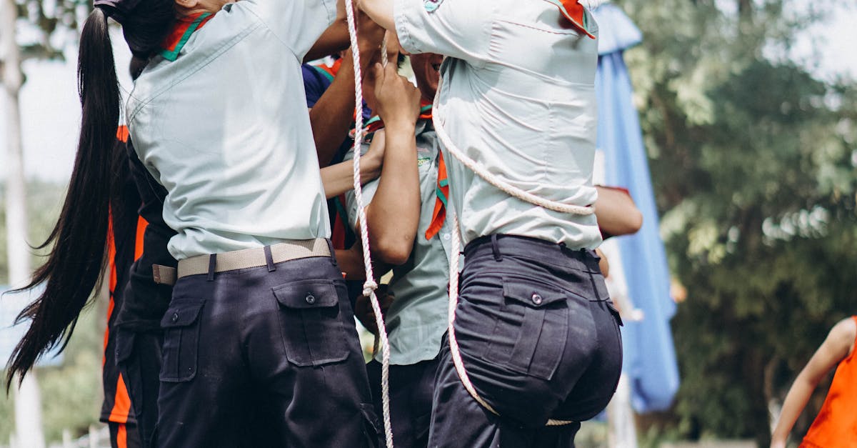 Teenagers collaborate in an outdoor teamwork exercise, showcasing leadership and cooperation.