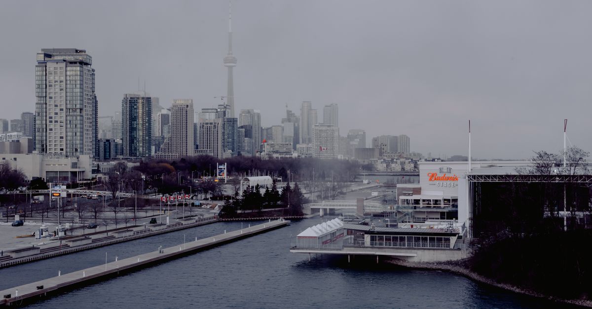 View from a modern Toronto condo balcony at sunrise, looking ahead to the 2025 condo market outlook