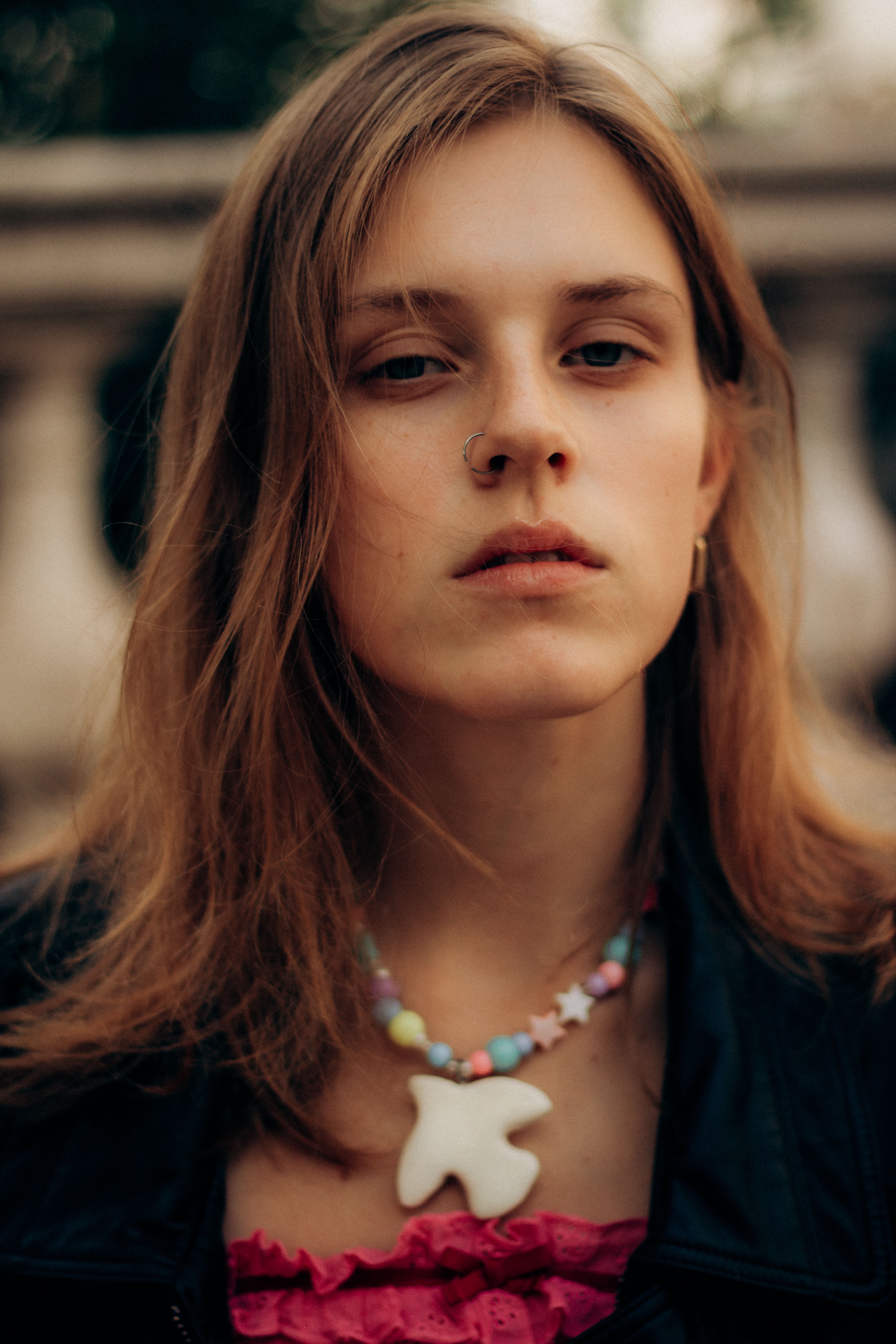Close-up portrait of a fashionable young adult on a city street in Marseille.