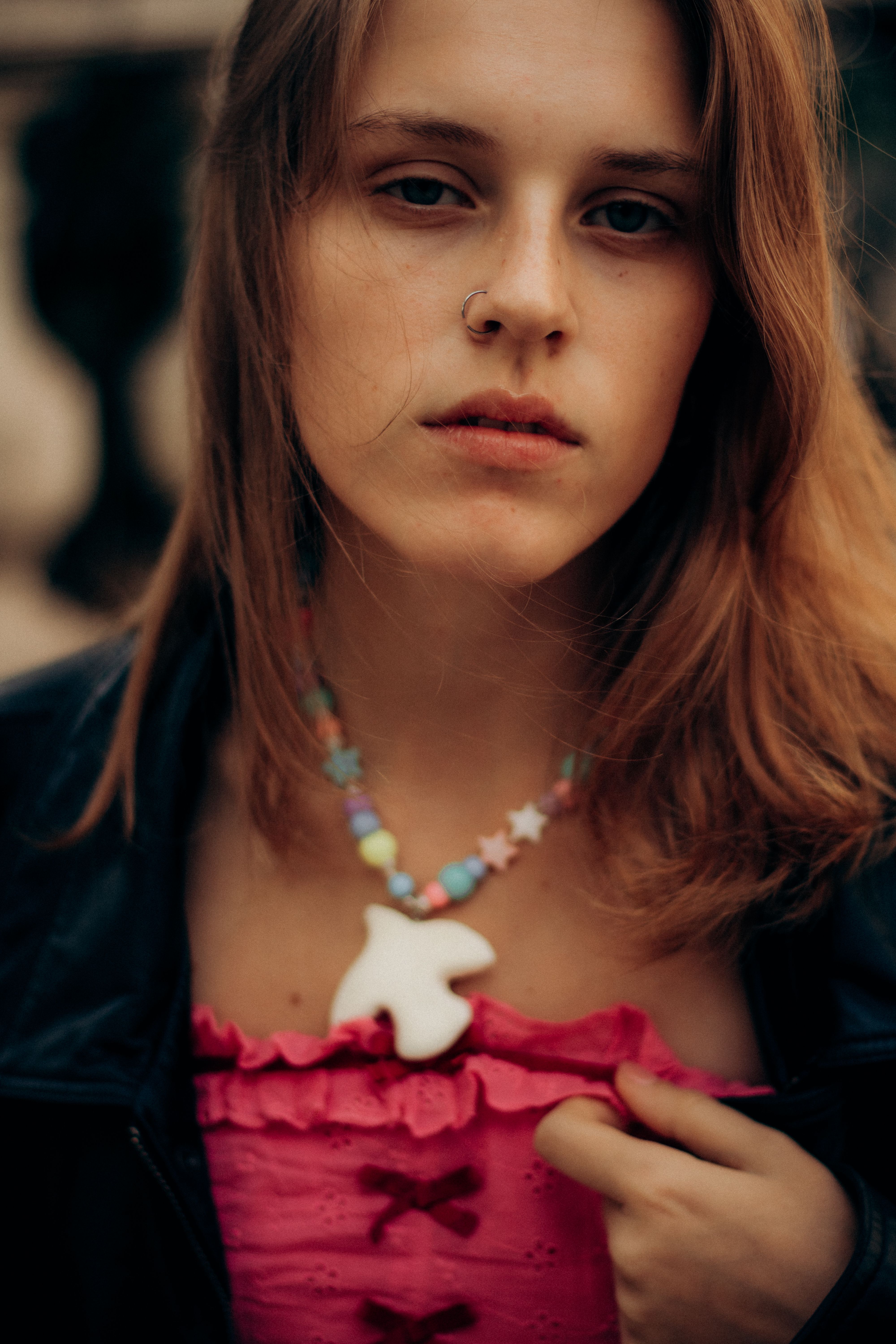 Artistic portrait of a young woman with colorful necklace in Marseille, France.
