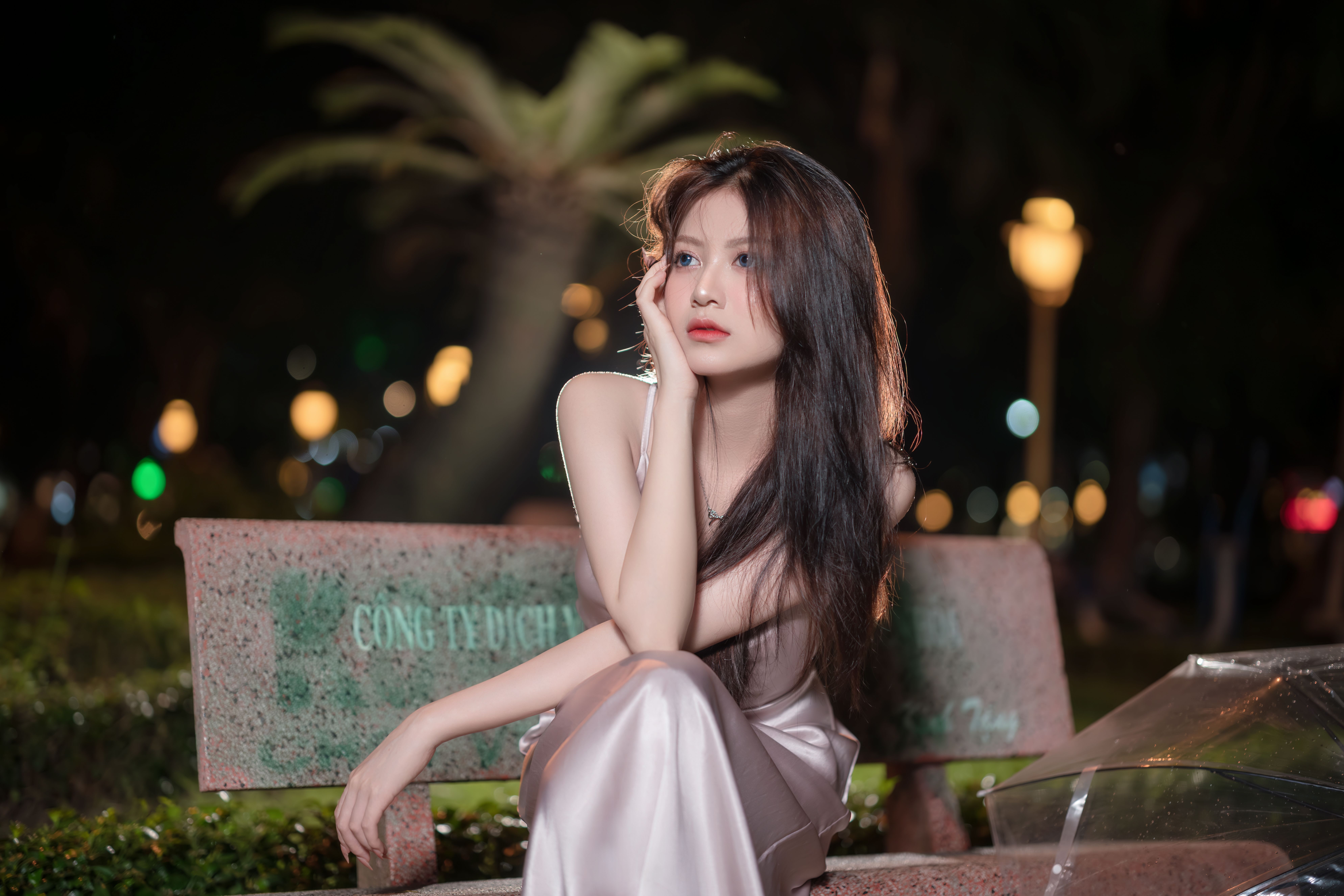 Elegant Woman in Satin Dress Posing Outdoors at Night · Free Stock Photo