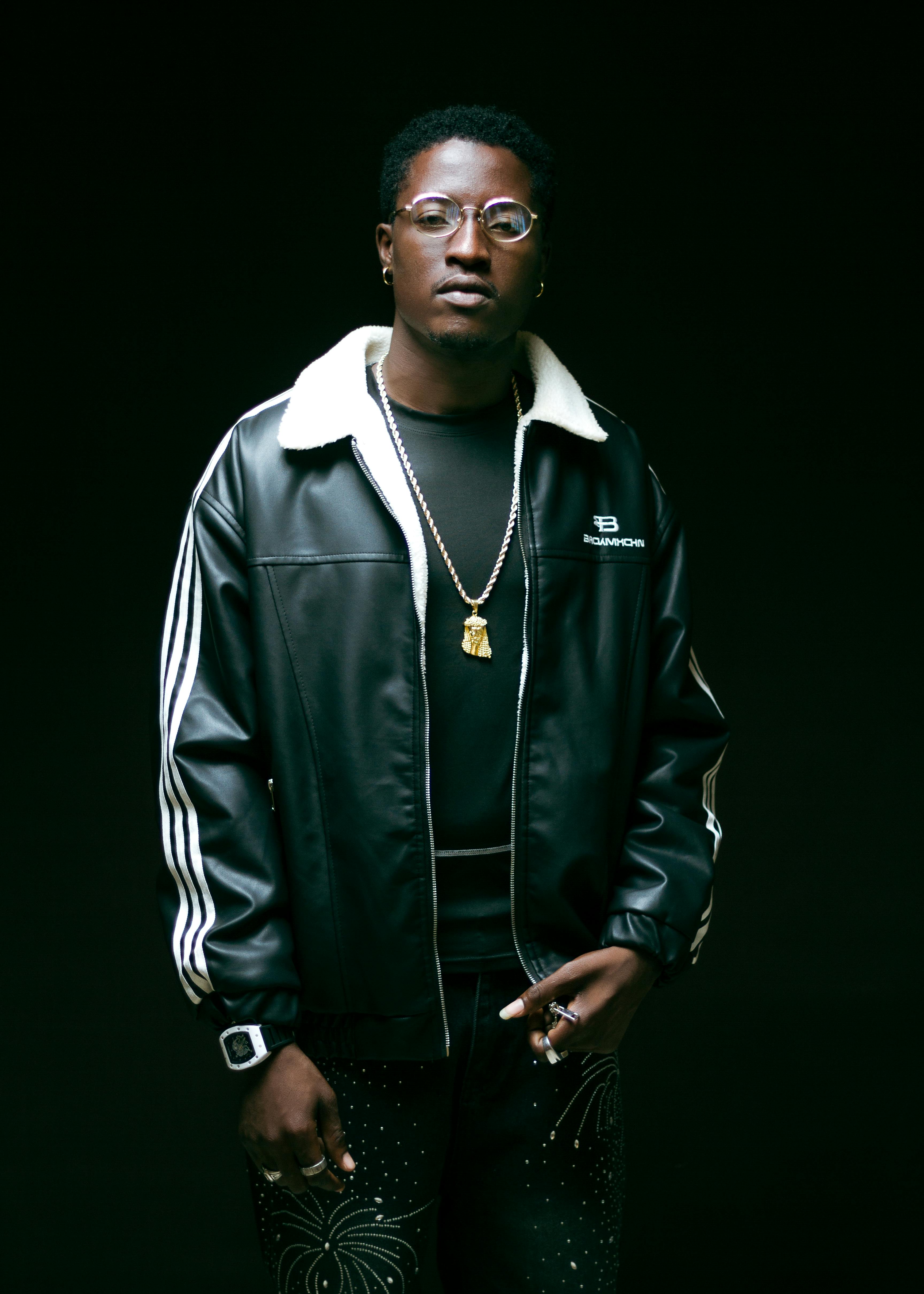 Stylish portrait of a man in a fashionable black jacket with accessories.