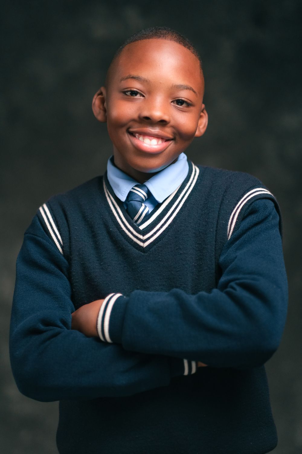 Student wearing a school sweater, shirt and tie